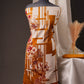 Rust Orange Pakistani Unstitched Suit with Embroidered Neck Patch & Dual Sleeve Borders.